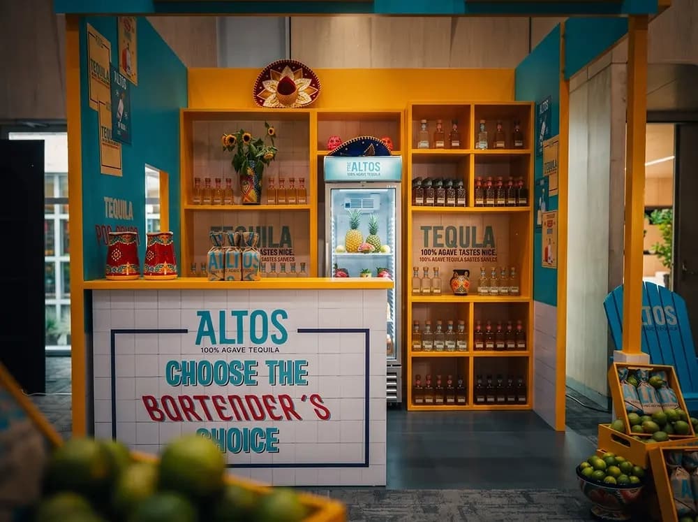 Altos tequila cantina bar activation with yellow joinery and tiled counter built by Proink