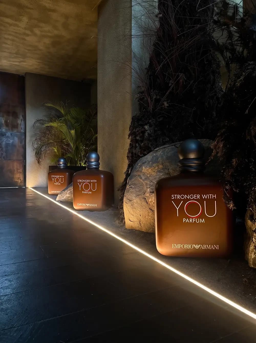 Oversized Emporio Armani fragrance replicas in a landscaped set built by Proink