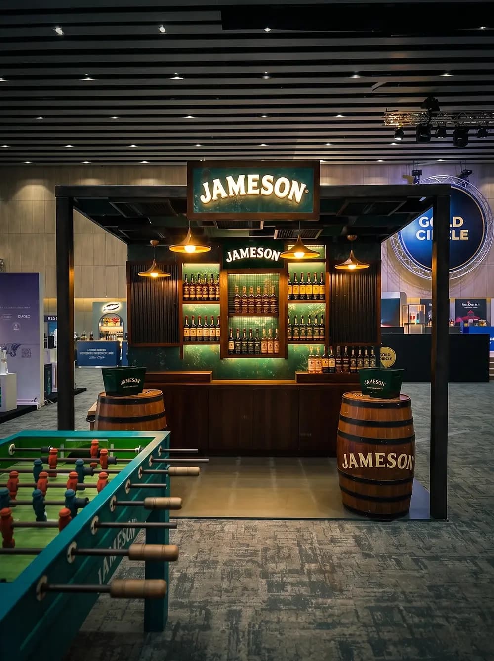 Jameson exhibition bar stand with backlit bottle display and whiskey barrels built by Proink