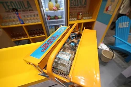 Angled presentation cradle holding an Altos bottle at the bar counter