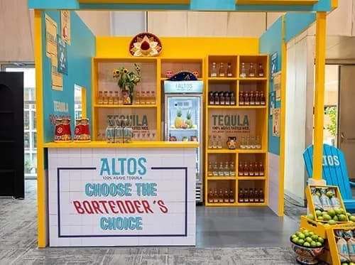 Altos cantina bar with a hand lettered tiled counter and yellow framed structure