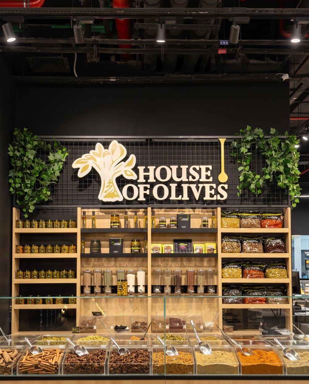 House of Olives deli island with refrigerated olive counter and tiered product displays