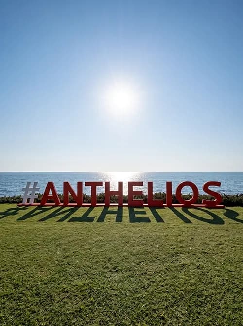 Dimensional ANTHELIOS hashtag letters installed on a lawn facing the sea