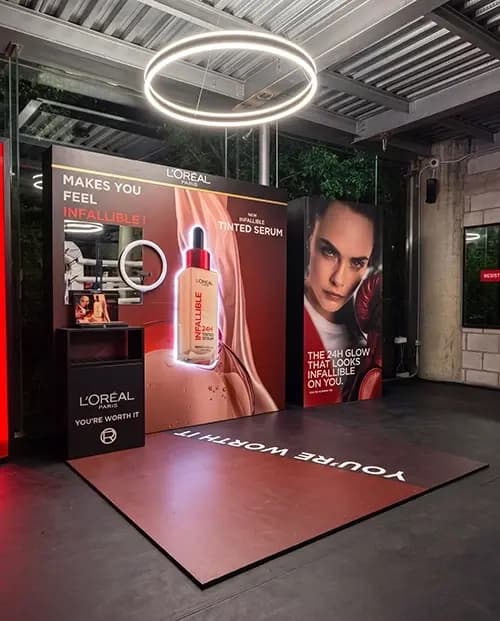 L'Oréal Infallible campaign backdrop with a mirrored product display unit
