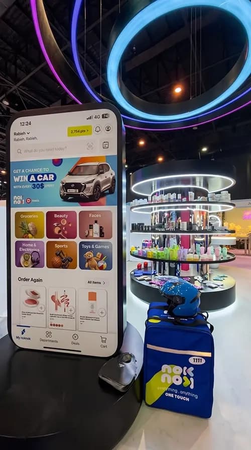 Product display zones and app screen framed by illuminated rings at the Nok Nok activation