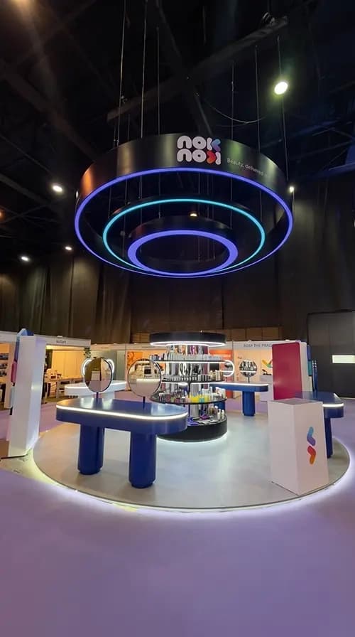 Nok Nok activation interior with a circular illuminated ceiling ring and product counters